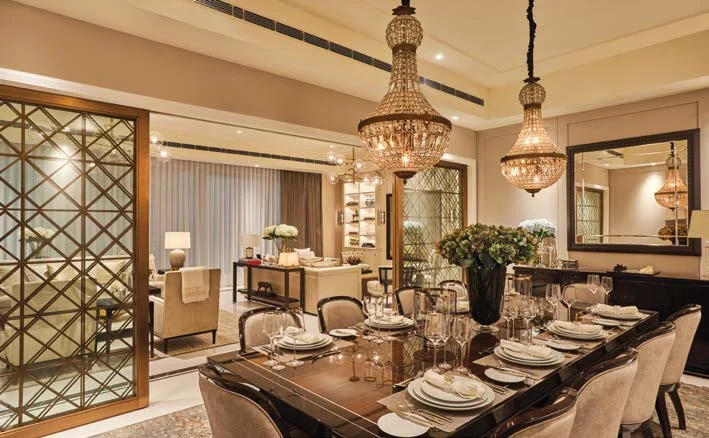 Published Camellias dining room with chandeliers and a formal dining table